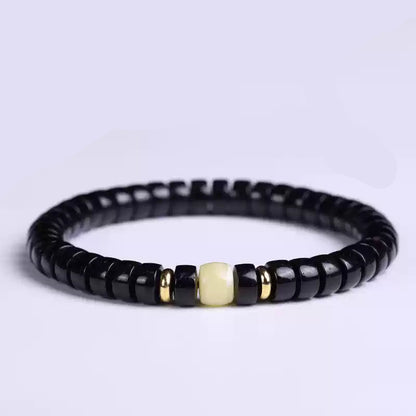 Black Coconut Shell Bracelet with Dzi Bead and Pill Disc Accents