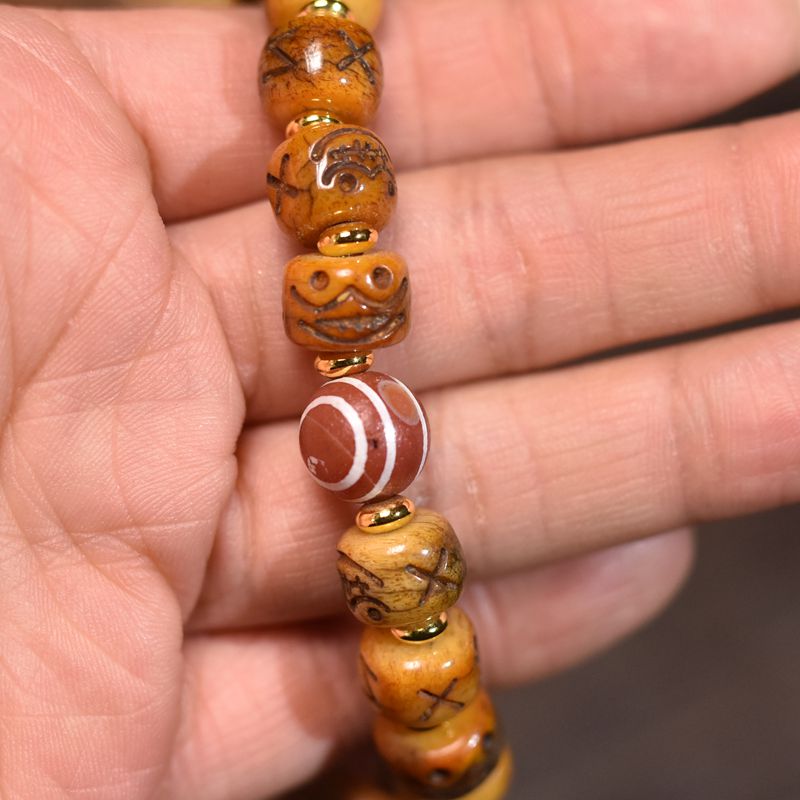 Circle of Life® Yak Bone Bracelet with Carved Symbols & Agate Accent